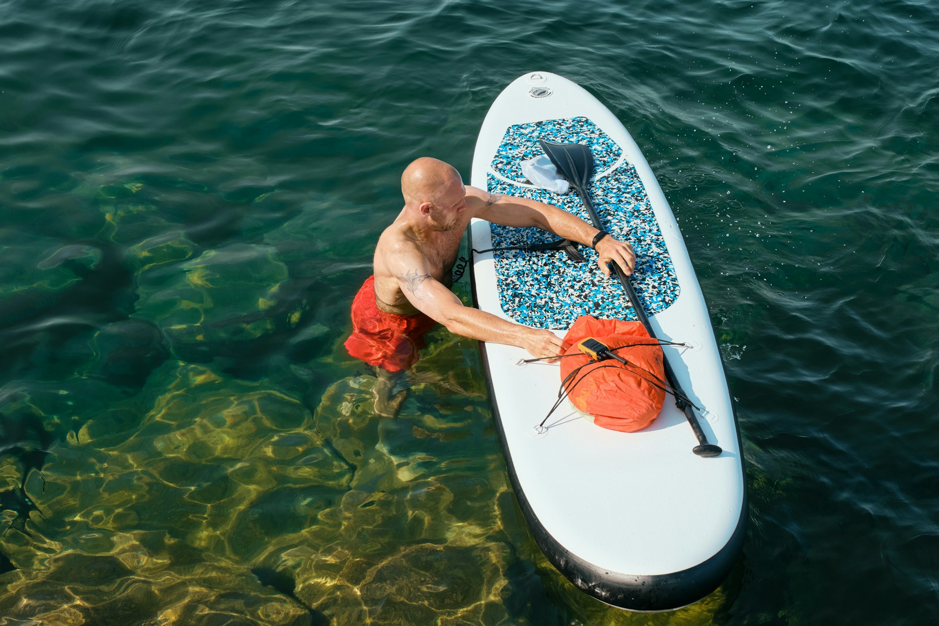 man paddleboarding |