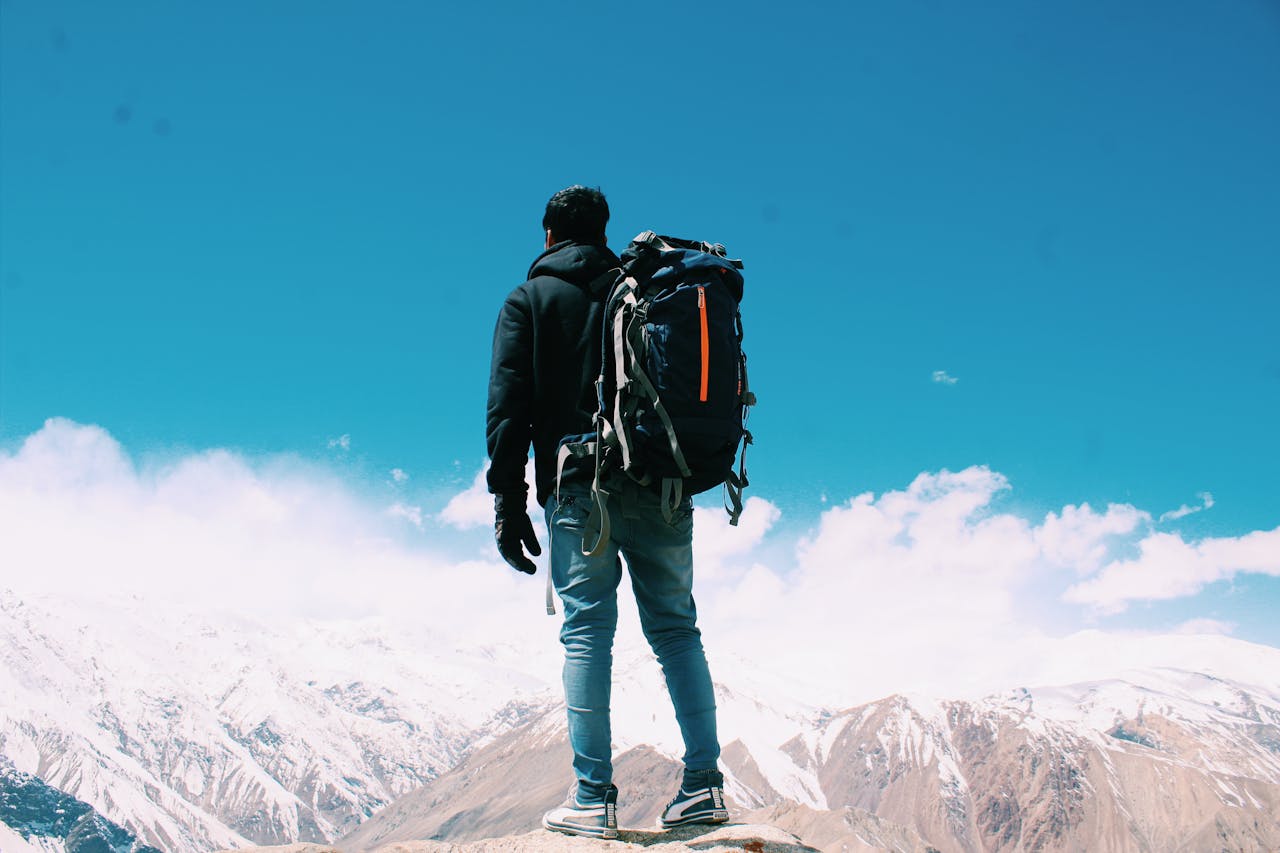 man standing on top of mountain |