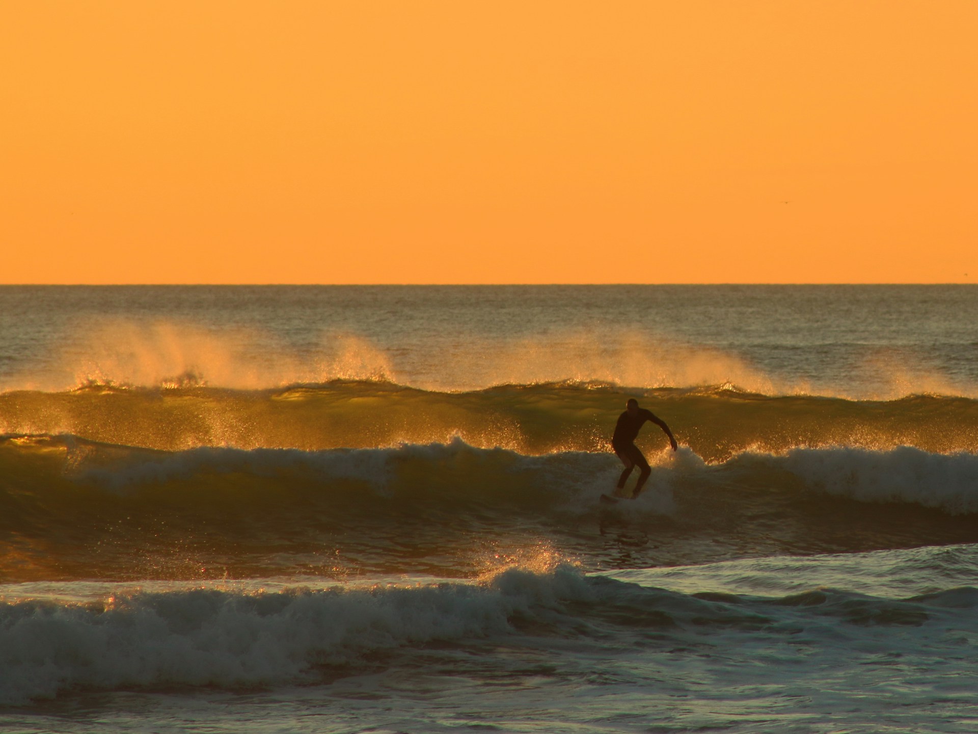 Man surfing at dusk | 